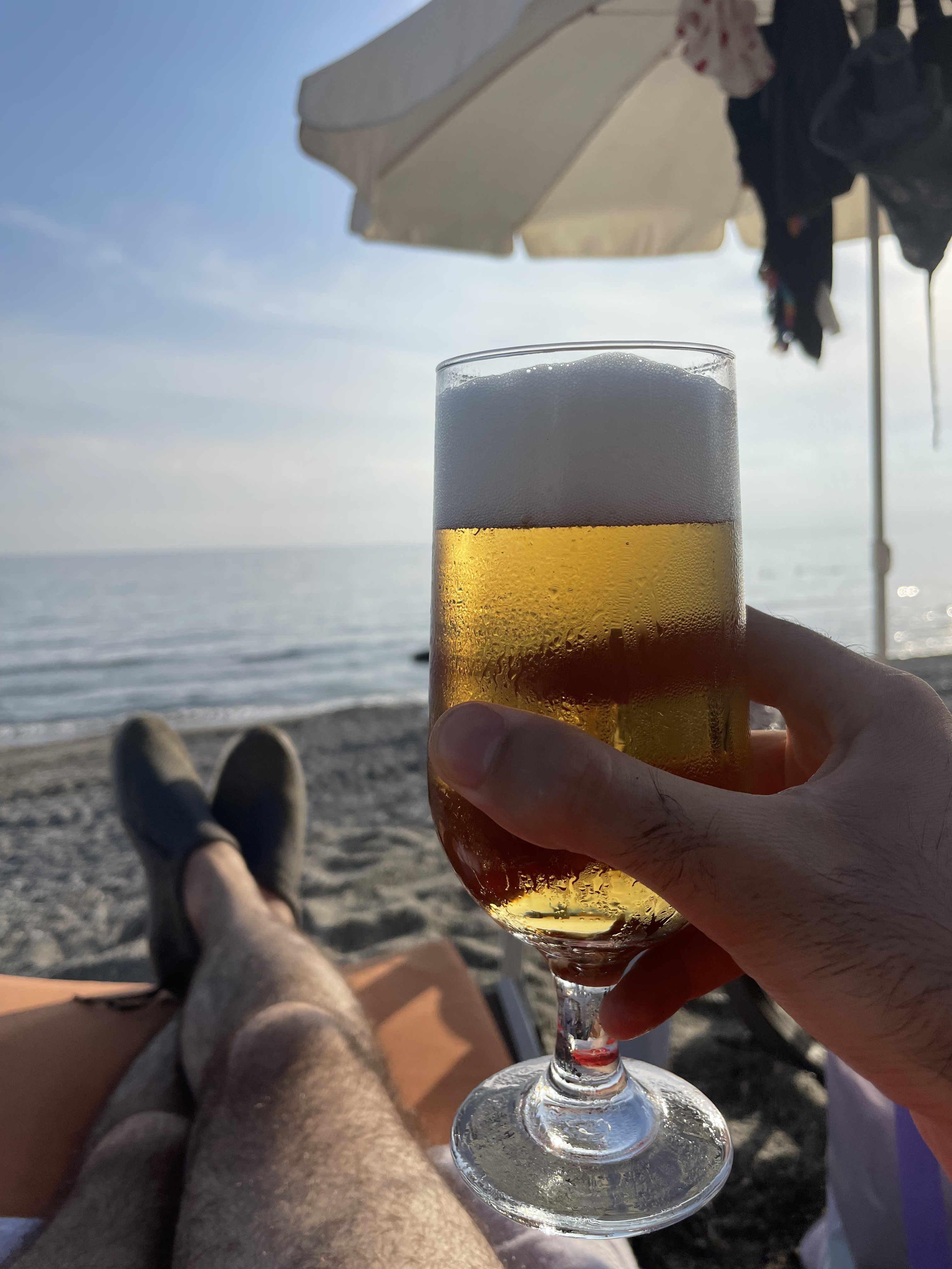 Holding a beer at the sea